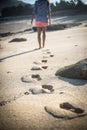 Woman Walks Alone on a Deserted Beach Royalty Free Stock Photo