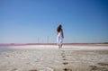 Woman walks alone on a deserted beach, solitude, serene, lonely concept. carefree vacation in nature Royalty Free Stock Photo