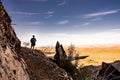 Woman Walks Along Cliffside trail over valley