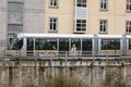 A woman walks alongside the city`s ground metro tracks with graffiti in the background Royalty Free Stock Photo