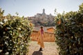 woman walks on background of cityscape of Siena old town in Italy