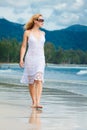 Woman walks on a beach Royalty Free Stock Photo