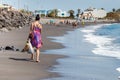 Woman walks on the beach with shopping Royalty Free Stock Photo