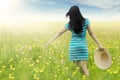 Woman walks on blossom meadow Royalty Free Stock Photo