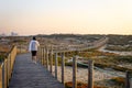 Woman Walks on Boardwalk