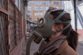 a woman walks down a gloomy street in a gas mask, mass infections and environmental problems, concept.