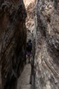 Woman Walks Down Narrow Slot Canyon