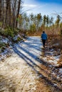 Woman walks through Dupont Forest on nice day in winter in North Carolina