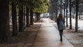 A woman walks in the park in Paris after the rain 2