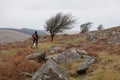 A woman walks her dog on Bodmin Moor in Cornwall in the UK