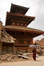 A woman walks outside a temple in Bhaktapur, Nepal Royalty Free Stock Photo