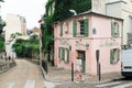 Woman walks past The Pink House in charming Montmartre