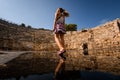 woman walks at ruins of amphitheatre and assembly hall ancient Lycian city Patara. Royalty Free Stock Photo