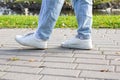 Woman walks on sidewalk, closeup of legs Royalty Free Stock Photo