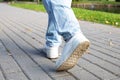 Woman walks on sidewalk, closeup of legs Royalty Free Stock Photo