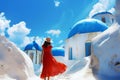 a woman walks through the white buildings and blue roofs in greece