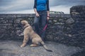 Woman by wall with Leonberger puppy Royalty Free Stock Photo