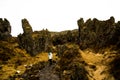 Woman wanders through lava formations in Iceland