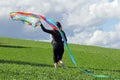 A woman wants to fly a kite in autumn