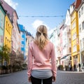 Woman wants to start her run. Rear view on the city street. jogging outdoors