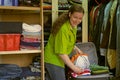 Woman in the wardrobe packs things into a suitcase Royalty Free Stock Photo