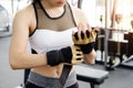 Woman ware a fitness glove in fitness gym.