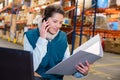 Woman warehouse worker or supervisor with smartphone Royalty Free Stock Photo