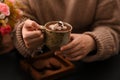 Woman in a warm sweater sipping hot dark chocolate Royalty Free Stock Photo