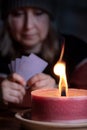 Woman with warm winter clothes is playing cards Royalty Free Stock Photo