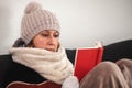 Woman with warm winter clothes is reading a book Royalty Free Stock Photo