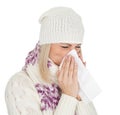 Woman in warm winter clothing sneezing from cold Royalty Free Stock Photo