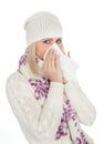 Woman in warm winter clothing sneezing from cold Royalty Free Stock Photo