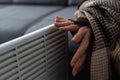 Woman warming hands near heater indoors, closeup Royalty Free Stock Photo
