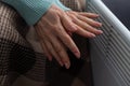 Woman warming hands near heater indoors, closeup Royalty Free Stock Photo