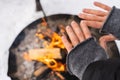 Woman warming up her hands by the fire pit Royalty Free Stock Photo