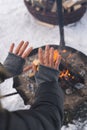 Woman warming up her hands by the fire pit Royalty Free Stock Photo