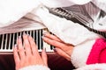 Woman warming up her hands on a white radiator Royalty Free Stock Photo