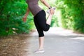 Woman warming up before jogging, outdoor exercise