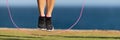 Woman warming up with jump rope outdoors Royalty Free Stock Photo