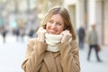 Woman warmly clothed looking a side in winter in the street Royalty Free Stock Photo