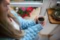 A woman warms her frozen hands against a mug of hot coffee. Royalty Free Stock Photo