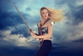 Woman warrior with cloudy sky background