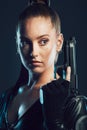 Woman, warrior and gun in studio with serious face for action, fight and safety from danger. Strong female model