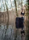 Woman Warrior Holding a Katana Sword in Mustic Lake waters Royalty Free Stock Photo