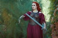 Woman warrior with a sword in her hand. Royalty Free Stock Photo