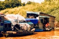 Woman wash dishes in floating house on Tonle Sap lake Royalty Free Stock Photo
