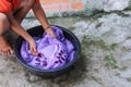 Woman wash hands dirty clothes in the basin black for cleansing Royalty Free Stock Photo