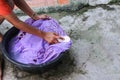 Woman wash hands dirty clothes in the basin black for cleansing Royalty Free Stock Photo