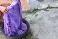 Woman wash hands dirty clothes in the basin black for cleansing Royalty Free Stock Photo