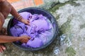 Woman wash hands dirty clothes in the basin black for cleansing Royalty Free Stock Photo